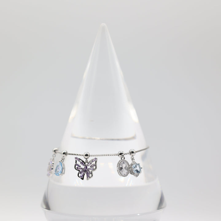 Costume Silver Toned Purple and White Glass Butterfly, flower, Teardrop Charm Adjustable Bracelet - 5.5 inches