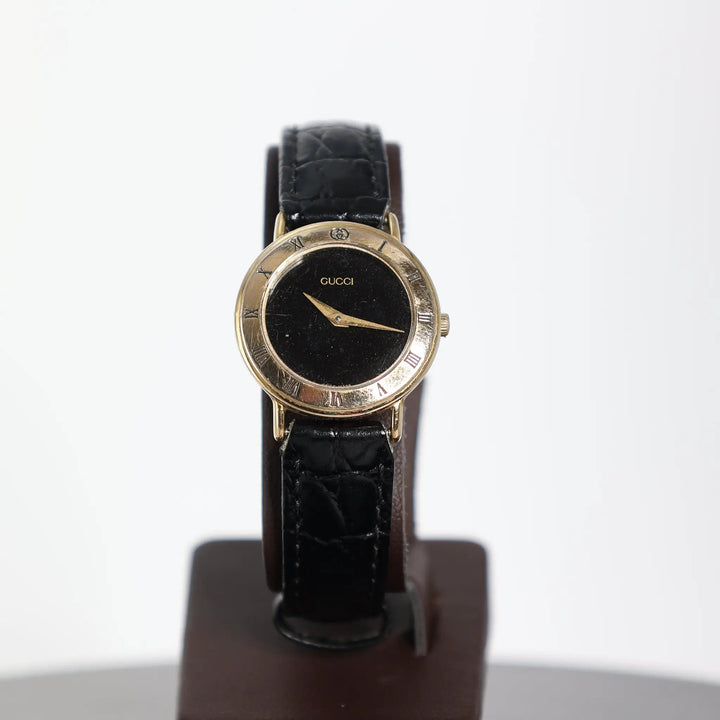 Gucci Vintage 3000.2.L Gold Plated Black Leather Watch by Annie McConnell's Renewed Elegance