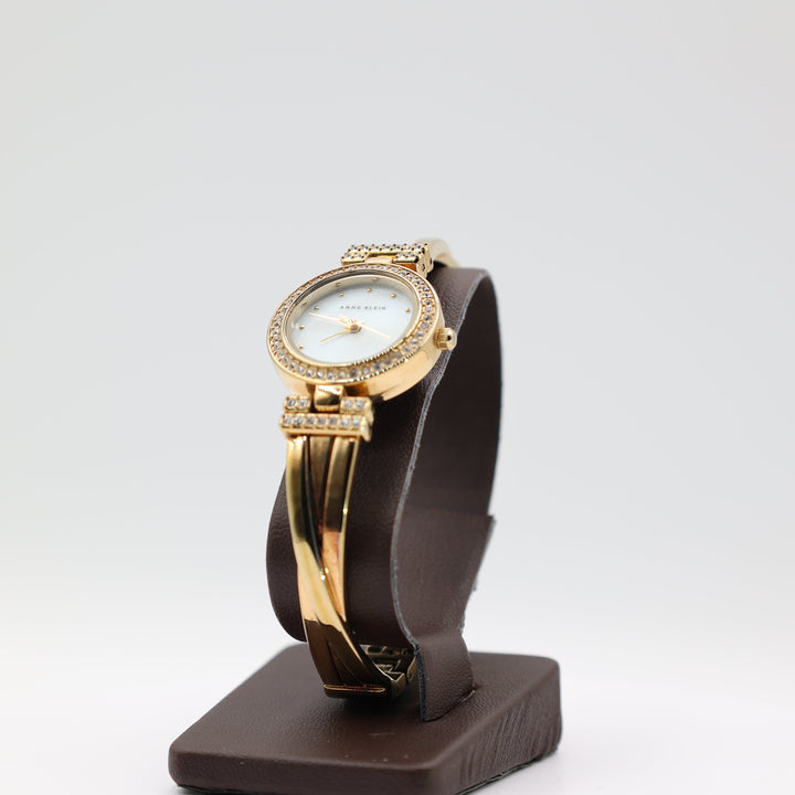 Anne Klein Gold Tone Watch with White Crystal Bezel With Multi Band Design Watch