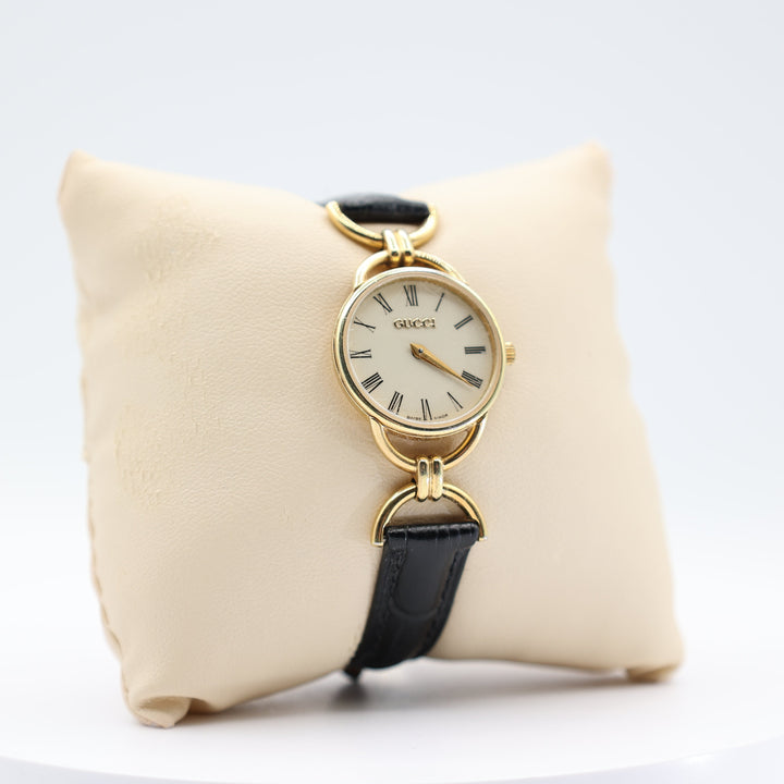 Gucci Women's Vintage Gold Tone Dainty Watch with Black Leather Strand