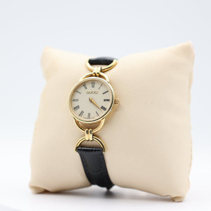Gucci Women's Vintage Gold Tone Dainty Watch with Black Leather Strand